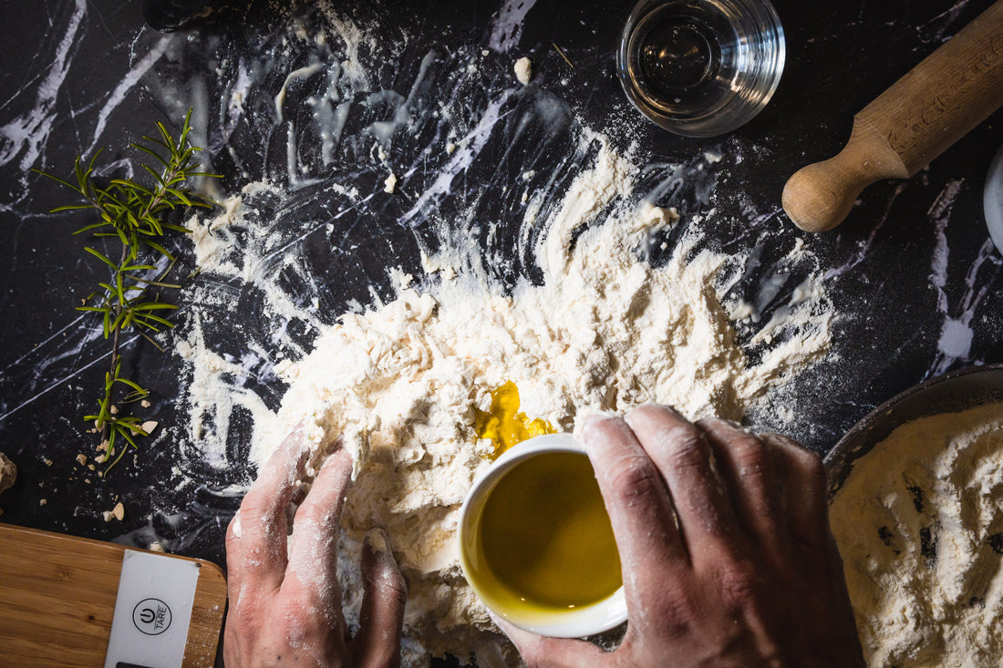 Ingredients to prepare a delicious pizza at home - olive oil and wheat flour