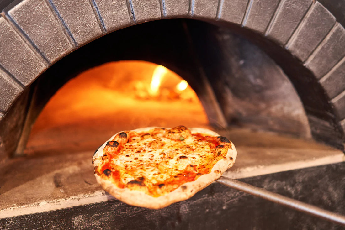Baked tasty margherita pizza in a traditional wood oven.