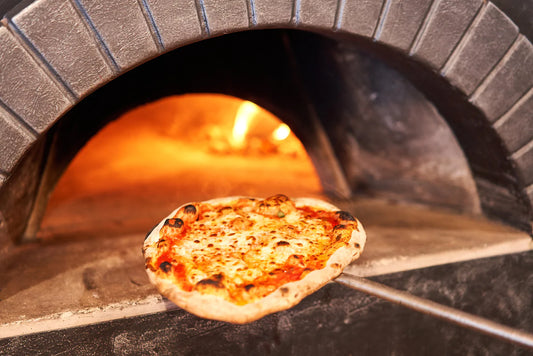 Baked tasty margherita pizza in a traditional wood oven.